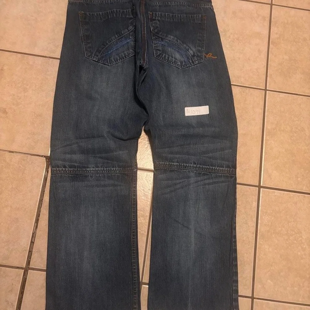 Navy blue baggy Rocawear denim jeans with a relaxed bootcut fit Size 36x34